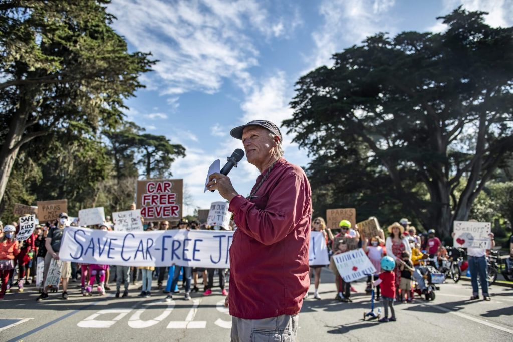 Musician Doug Goodkin led people in a call-and-response song in support of car-free JFK at the February 12 rally. Photo by Jim Watkins.