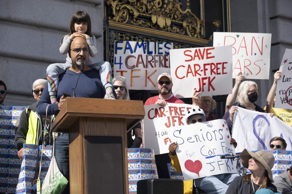 Deep Jawa of San Francisco League of Conservation Voters had his daughter join him on March 1 to talk about why car-free JFK is climate action. Photo by William McLeod.