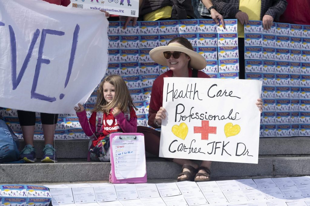 At the March 1 rally, a child brought her own petition to save car-free JFK. Photo by William McLeod.