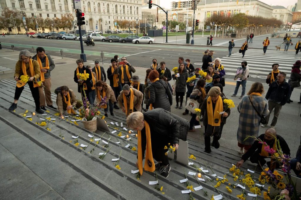 After the memorial walk, flowers were laid on the steps of City Hall.