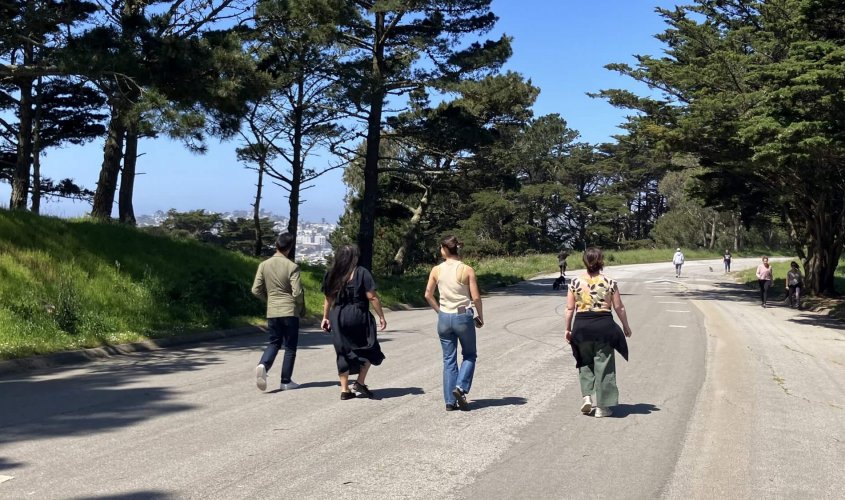 Photo of four individuals walking along Shelley Drive in McLaren Park.