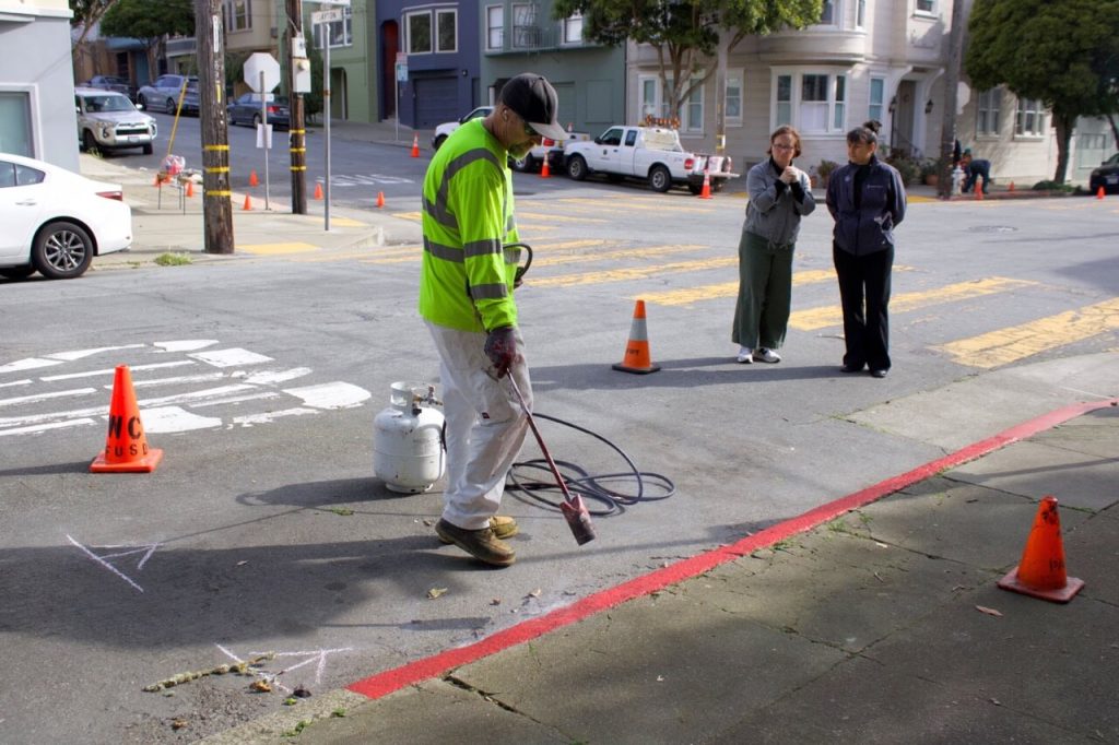 SFMTA crews seal in the students' paint job. Photo by Fiona Yim. 